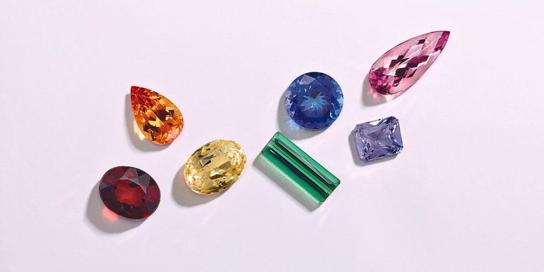 Assorted loose gemstones in vibrant colors. Shop by gemstone color at Rare Earth Jewelry to find your perfect piece.