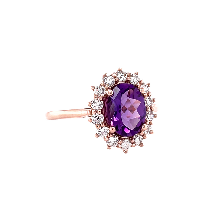 A vintage inspired Amethyst and Diamond ring with a feminine cluster design and diamond accents.  An oval cut  natural Amethyst gemstone ring from Rare Earth Jewelry.