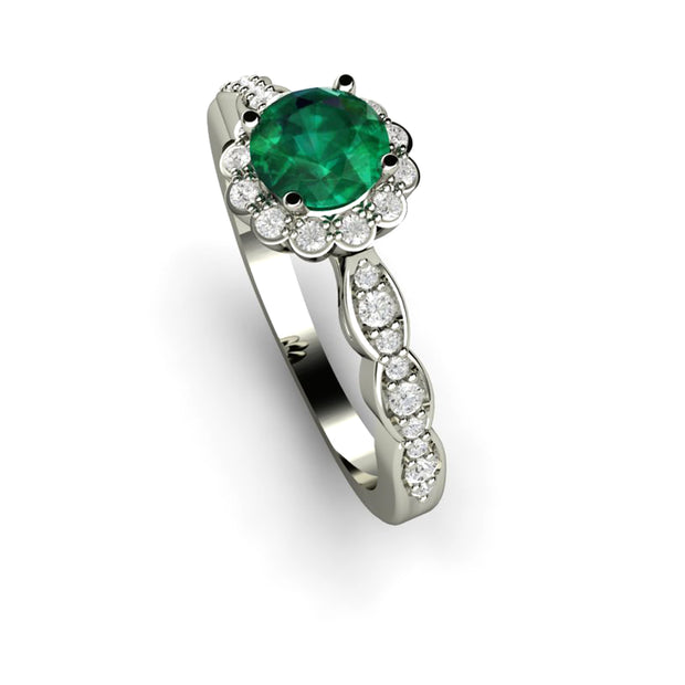 Vintage style emerald engagement ring with scalloped band and diamond halo.