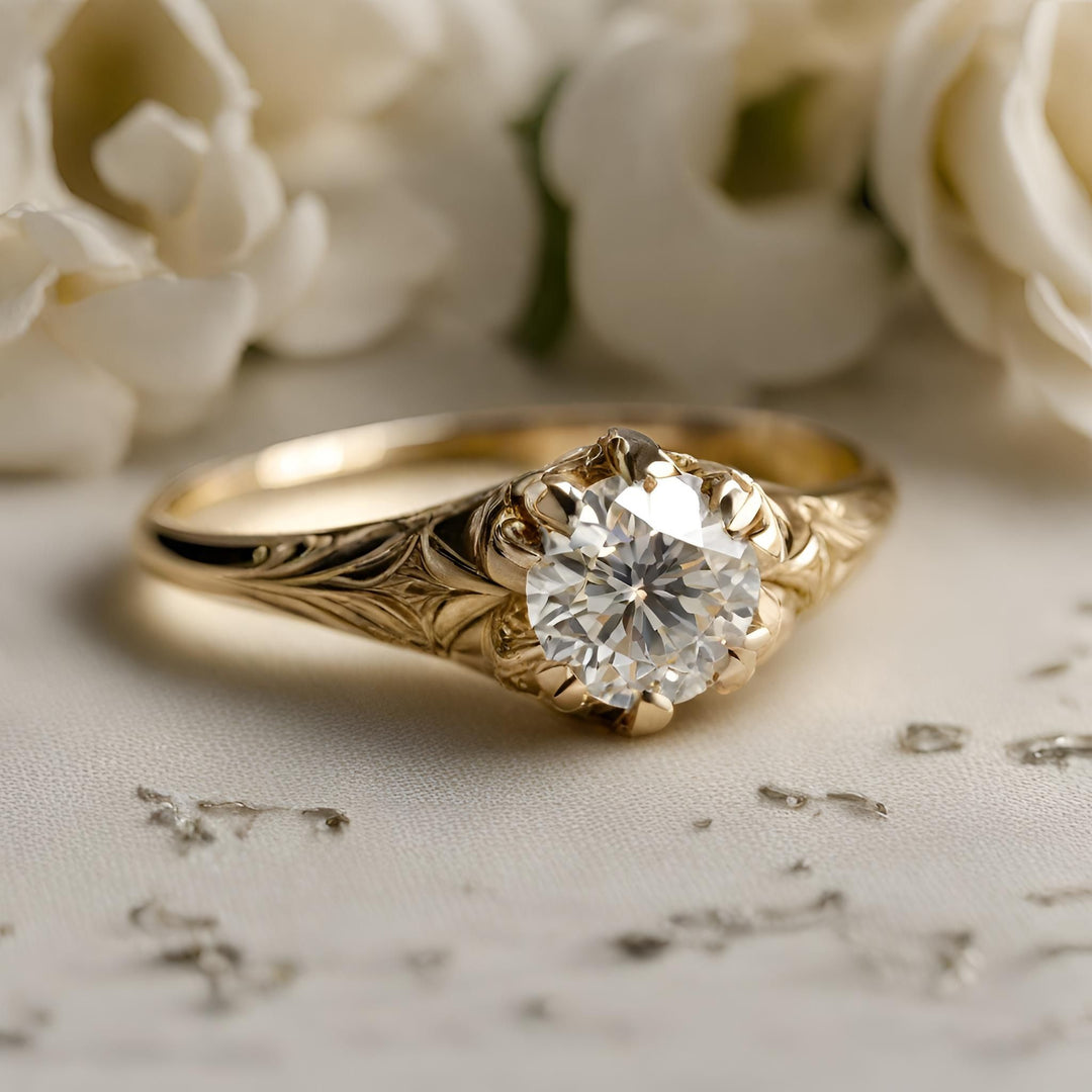 An antique style diamond engagement ring with a round diamond in an art deco design in 18K yellow gold from Rare Earth Jewelry.