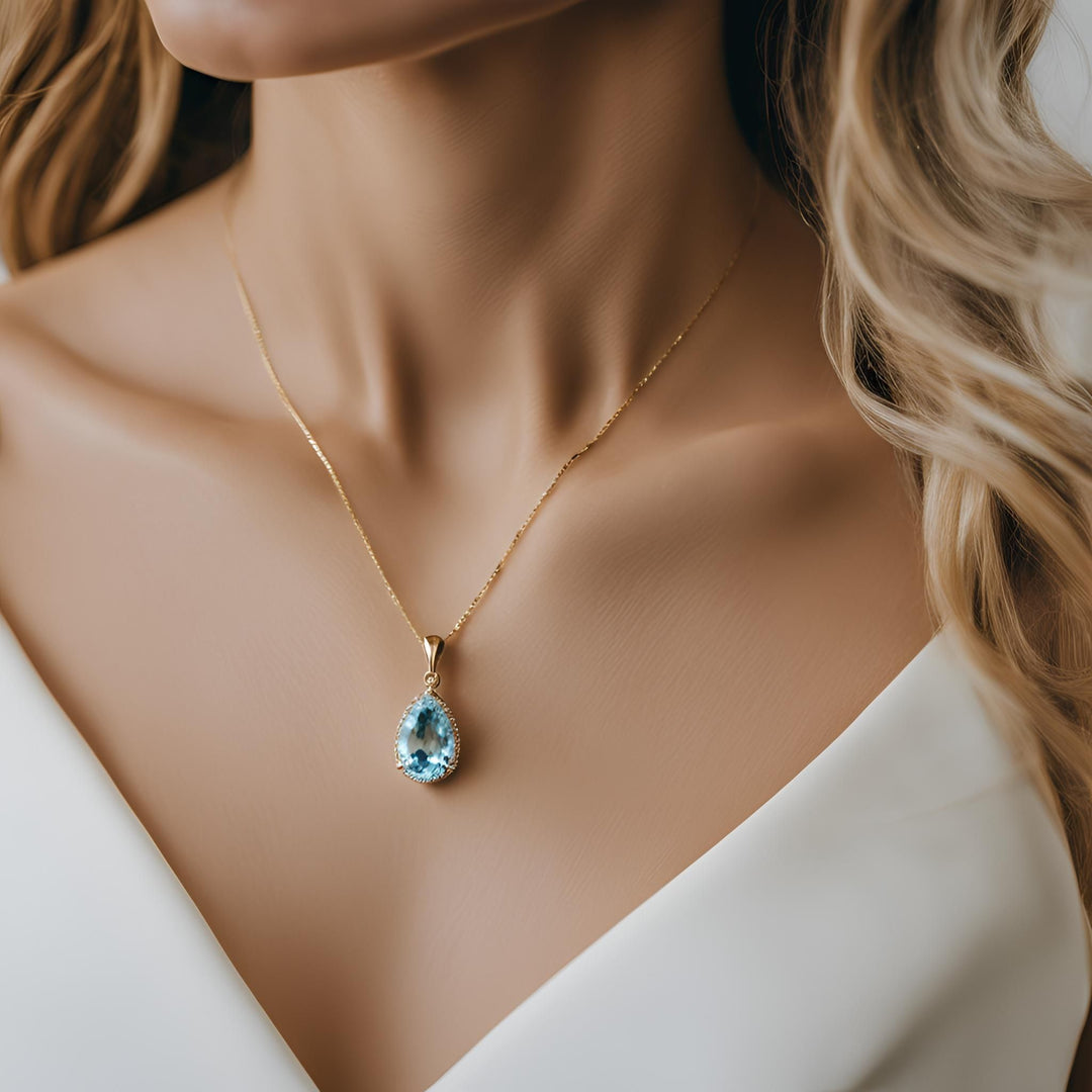 A pear cut natural Aquamarine pendant, a 14K Gold Aqua necklace from Rare Earth Jewelry.