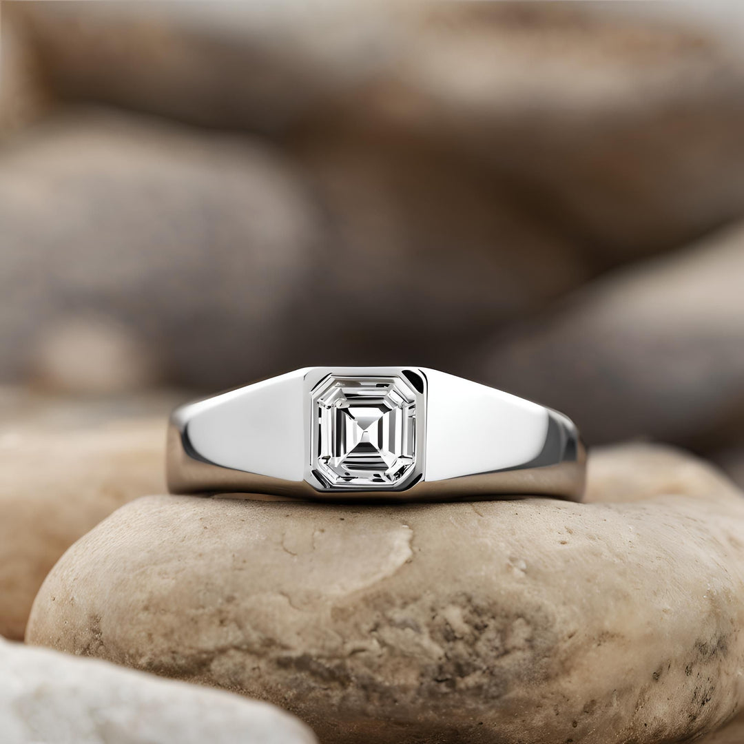 An asscher cut diamond ring in a modern bezel set design from Rare Earth Jewelry.