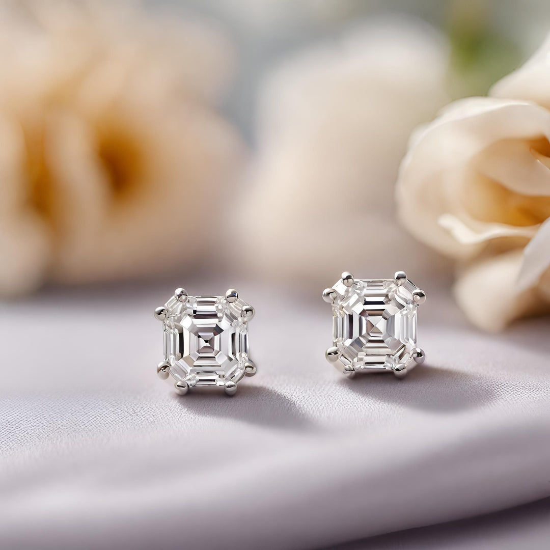 A pair of asscher cut lab created diamond earrings with double prongs. Lab grown diamond studs in 14K or 18K Gold or Platinum from Rare Earth Jewelry.