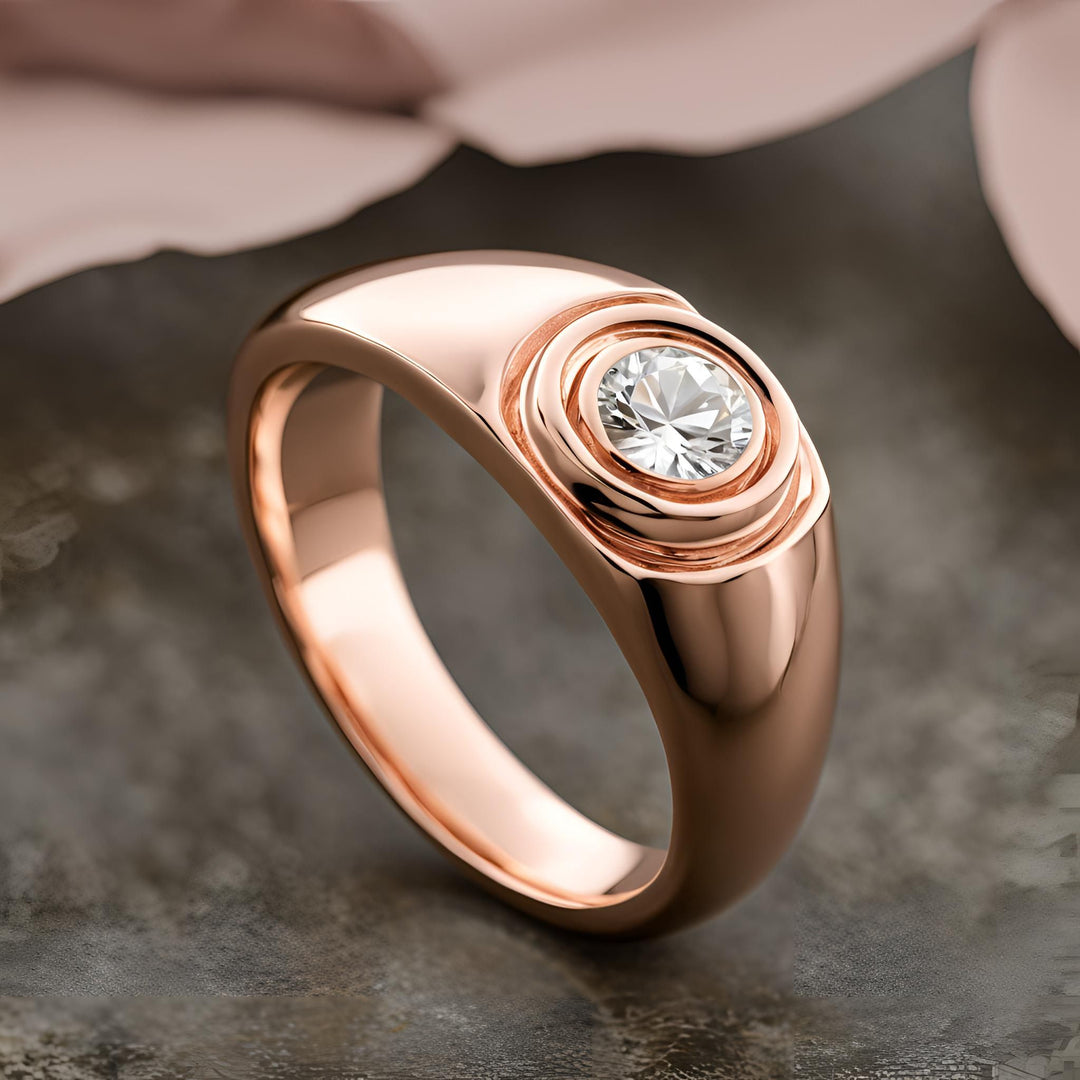 A round bezel set diamond ring with an asymmetrical design in rose gold from Rare Earth Jewelry.