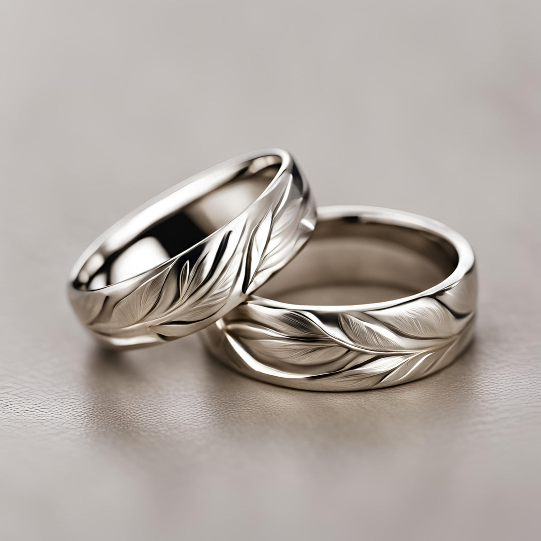 A pair of contemporary wedding bands with a modern sculpted leaf pattern design from Rare Earth Jewelry.