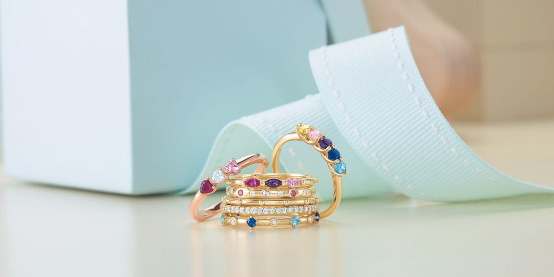 Handcrafted Stack of custom birthstone and mother’s rings in rose and yellow gold from Rare Earth Jewelry