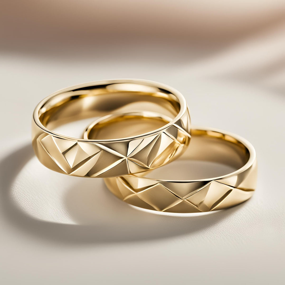 A pair of gold wedding rings with a modern geometric design of faceted triangles from Rare Earth Jewelry.