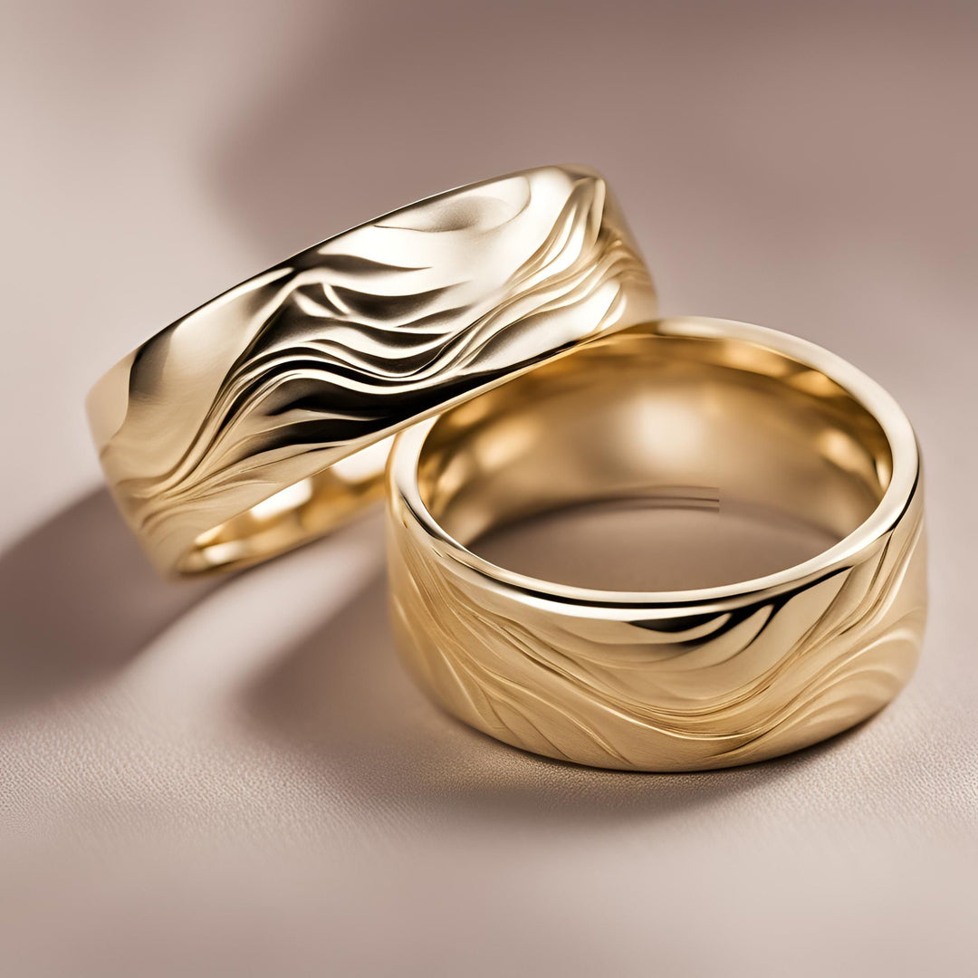 A pair of custom wedding bands with a wave pattern water design in 14K or 18K Gold from Rare Earth Jewelry.