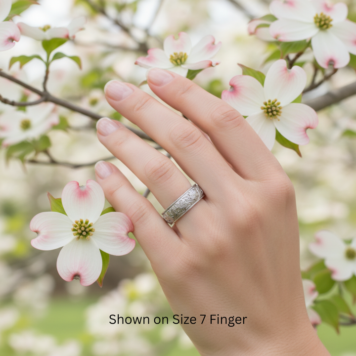 Dogwood blossom wedding band shown on size 7 finger, 8mm wide vintage inspired engraved floral ring in 14K white gold | Rare Earth Jewelry