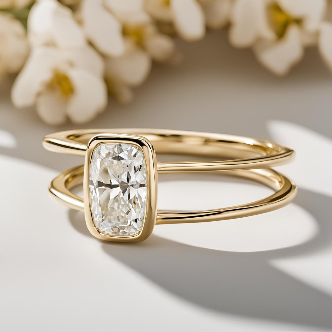 An elongated cushion cut lab grown diamond engagement ring in a simple bezel setting with double bands split shank in 14K or 18K Gold from Rare Earth Jewelry.