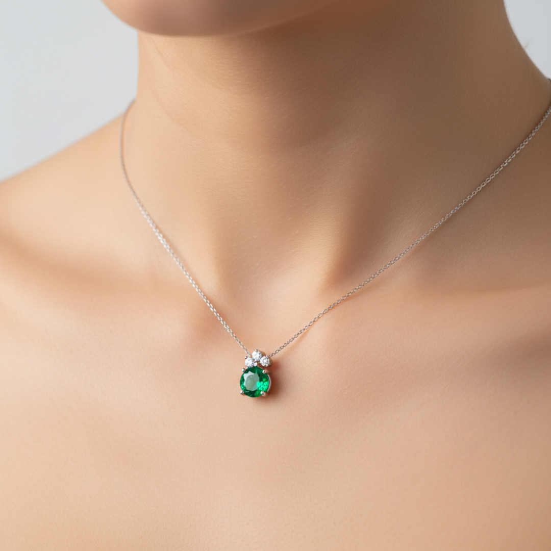 Dainty emerald and diamond necklace on model featuring round emerald pendant, May birthday gift idea | Rare Earth Jewelry