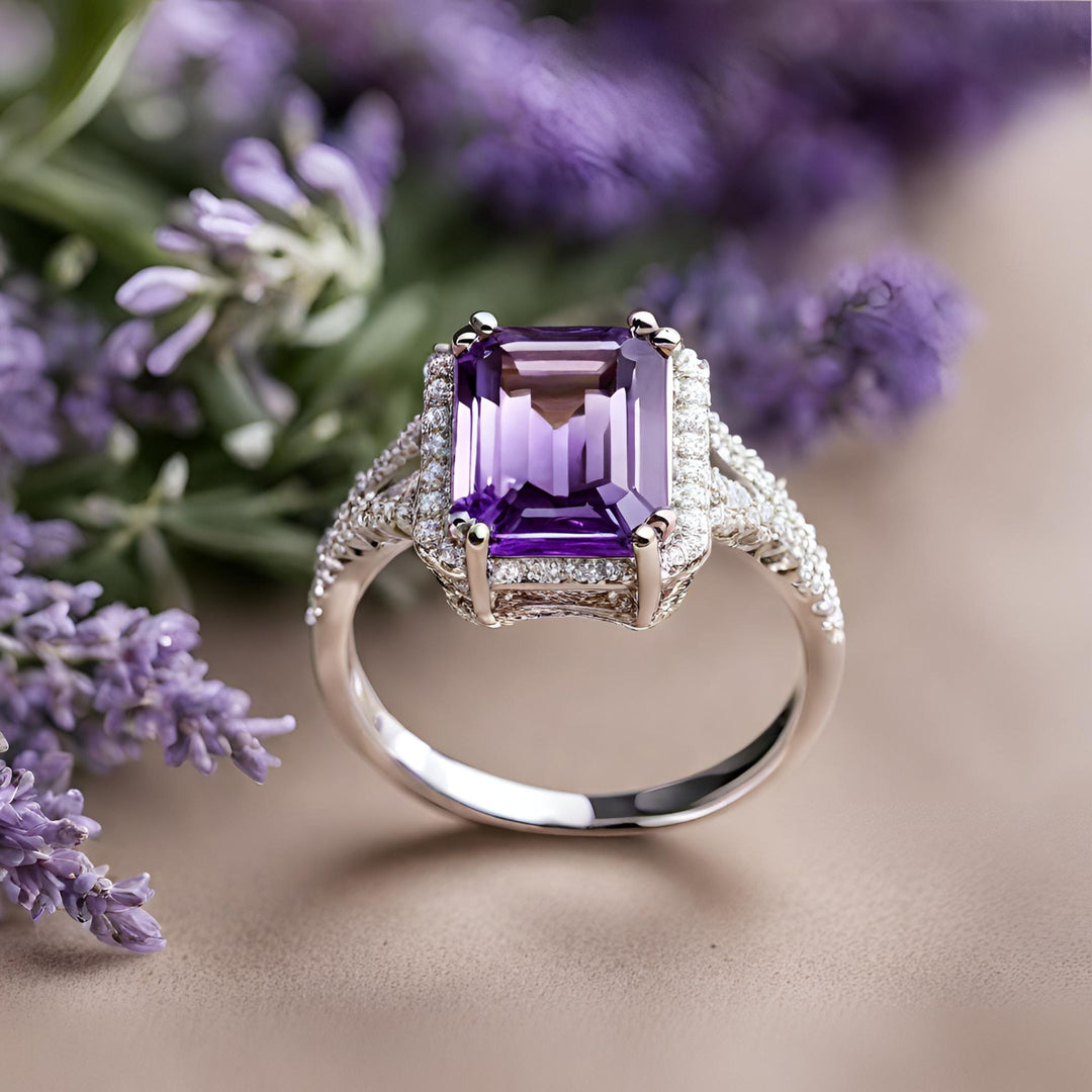 An emerald cut natural Amethyst ring with pave set diamond halo and split band in white gold from Rare Earth Jewelry.