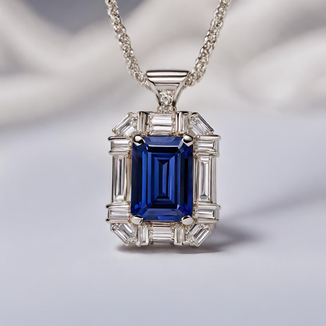 A natural emerald cut Blue Sapphire pendant with diamond baguettes from Rare Earth Jewelry.