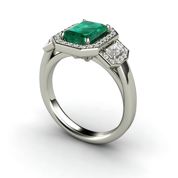 Emerald cut three stone engagement ring with pave set diamond halo and a large green emerald.