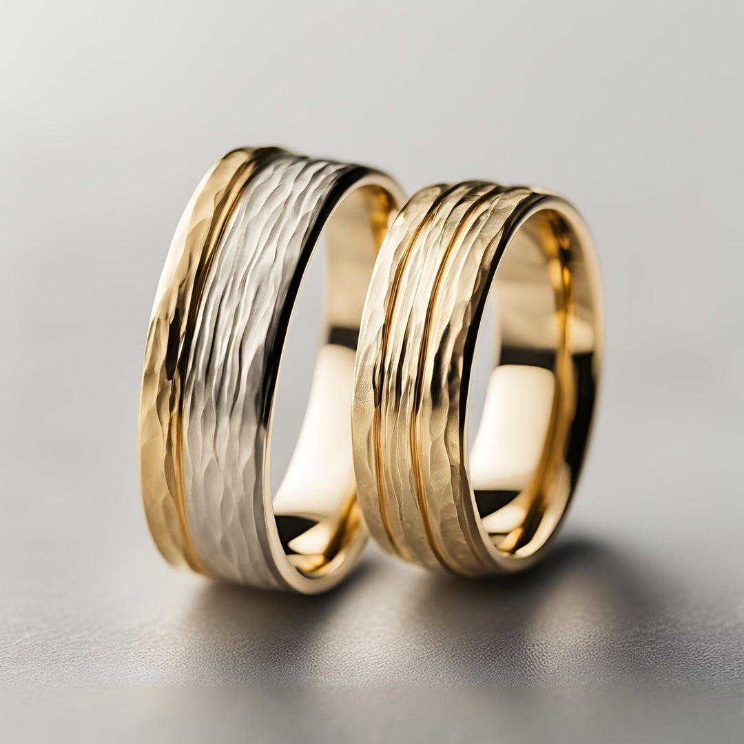 A pair of his and hers hammered wedding bands with grooves and a lightly hammered finish in two-tone gold handmade by Rare Earth Jewelry. 