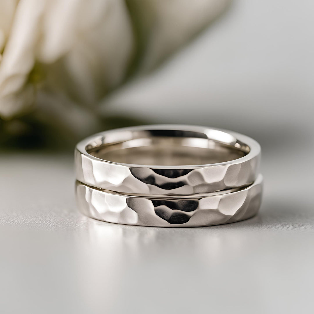 A matching pair of narrow hammered wedding bands in white gold from Rare Earth Jewelry.