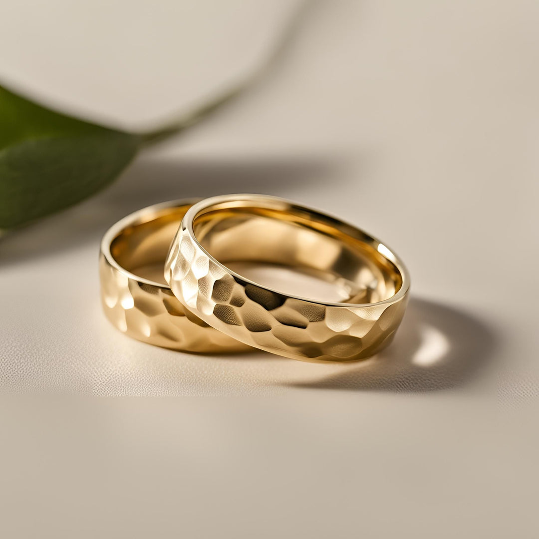 A pair of hammered gold wedding rings with a unique geometric design for men or women from Rare Earth Jewelry.