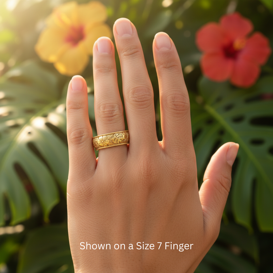 Yellow gold monstera leaf and hibiscus flower engraved ring, tropical floral unisex wedding band worn on size 7 finger | Rare Earth Jewelry
