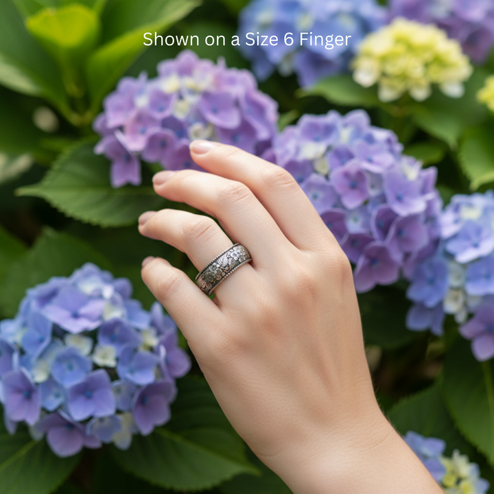 Hydrangea flower wedding band in 14K white gold with antique patina shown on a size 6 finger, engraved botanical unisex ring for men or women, nature inspired floral ring | Rare Earth Jewelry