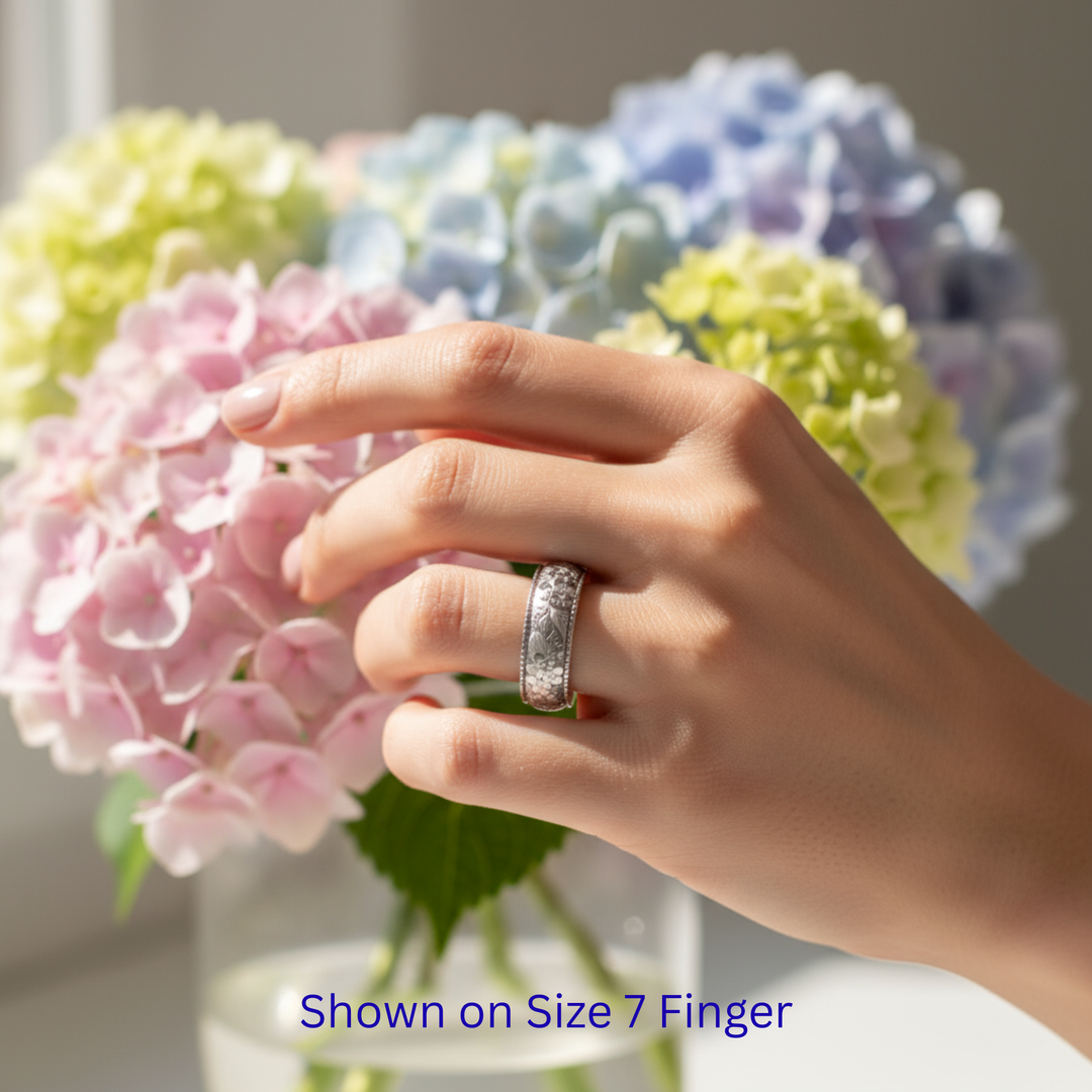 Hydrangea wedding band on hand, engraved 8mm floral ring with romantic botanical detail | Rare Earth Jewelry