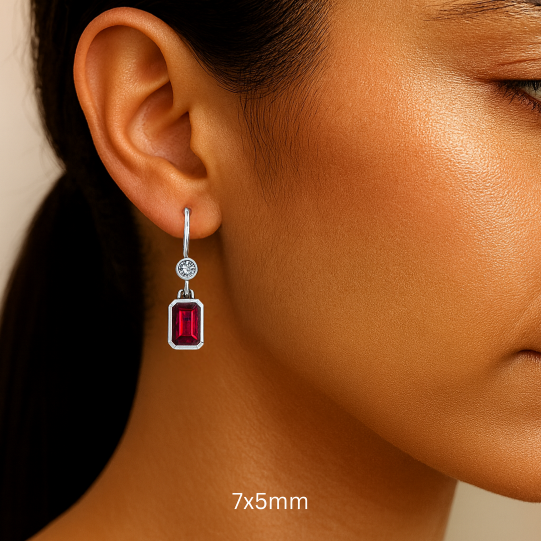 7x5mm Emerald Cut Ruby Earrings with Diamonds shown on the Ear, Bezel Set Ruby Dangle Earrings on French Ear Wires in 14K or 18K Gold and Platinum | Rare Earth Jewelry