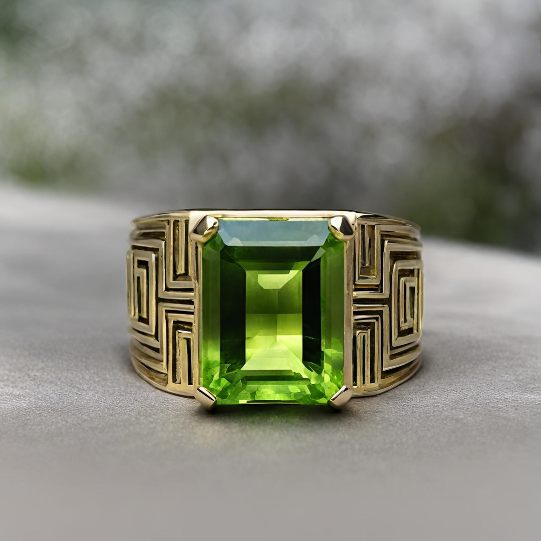 A large emerald cut peridot ring with a geometric greek key design in 14K Gold from Rare Earth Jewelry.