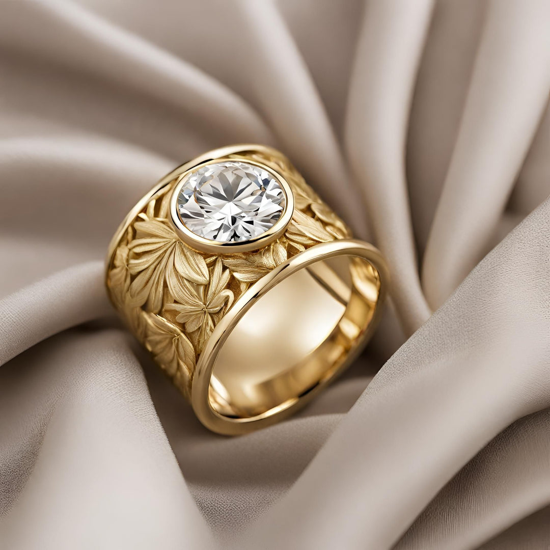 A large round lab grown diamond ring in 14K Gold wide cigar band statement ring with bezel set lab created diamond and leaf design from Rare Earth Jewelry.