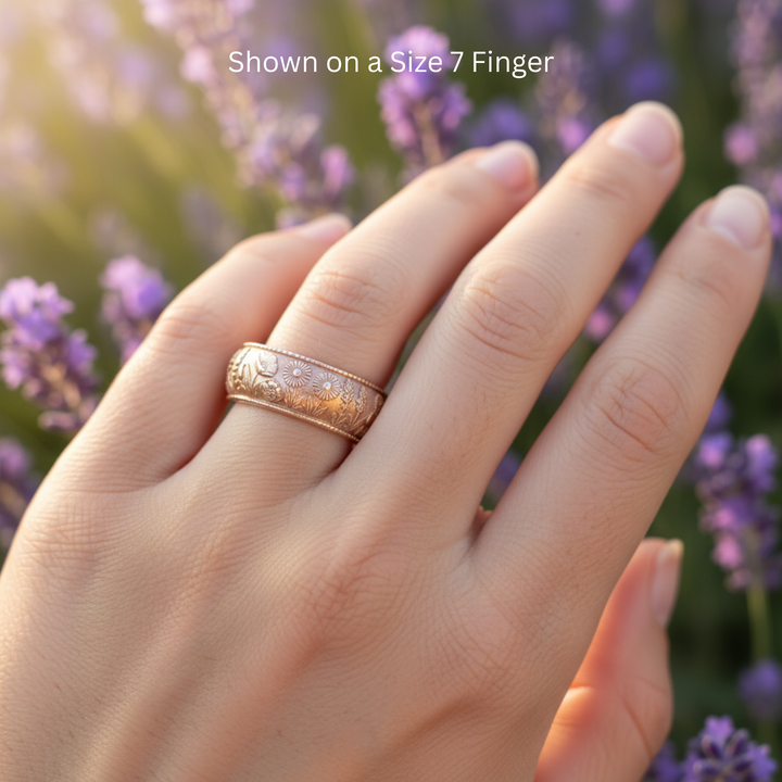 Lavender and wildflower floral wedding band in 14K rose gold shown on size 7 finger, engraved botanical design | Rare Earth Jewelry