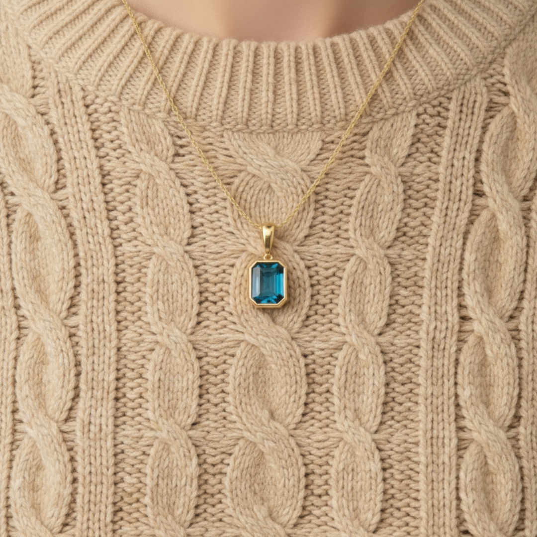 Close up of natural london blue topaz emerald cut necklace in 14k yellow gold | Rare Earth Jewelry