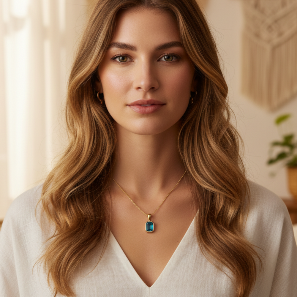 natural london blue topaz emerald cut pendant necklace on model in 14k yellow gold | Rare Earth Jewelry