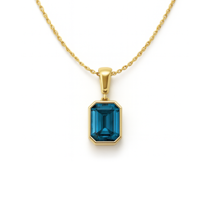 3ct emerald cut london blue topaz necklace in 14k yellow gold, blue topaz pendant in bezel setting | Rare Earth Jewelry