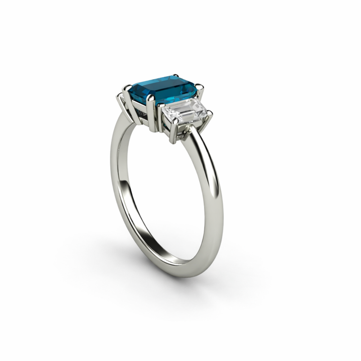Side View Of Emerald Cut London Blue Topaz Three Stone Engagement Ring With Lab Diamond Accents | Rare Earth Jewelry