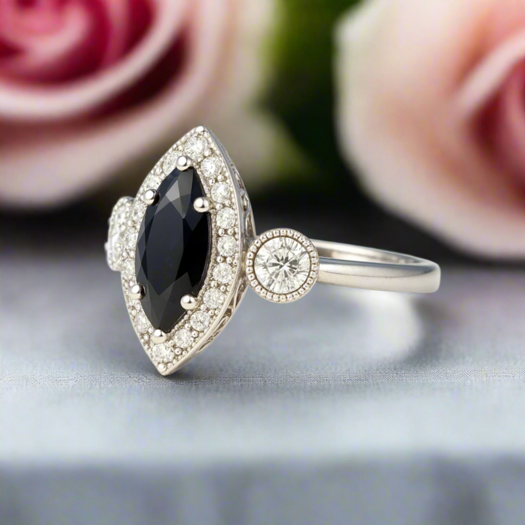 A marquise cut natural black diamond engagement ring with a vintage inspired art deco design, diamond halo, filigree and milgrain.  Antique style engagement rings from Rare Earth Jewelry