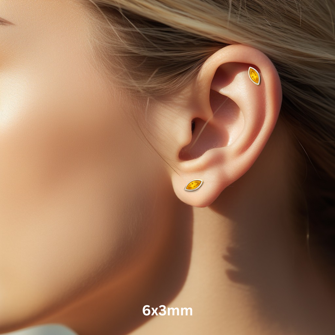 Marquise Cut Citrine Stud Earrings for Earlobe or Helix Piercings, 14K Gold Peridot Studs in Modern Minimalist Bezel Set Style, November Birthstone Earrings for Men or Women, Available as Single Earring or in Pairs, 6x3mm Size Shown on Ear Model | Rare Earth Jewelry
