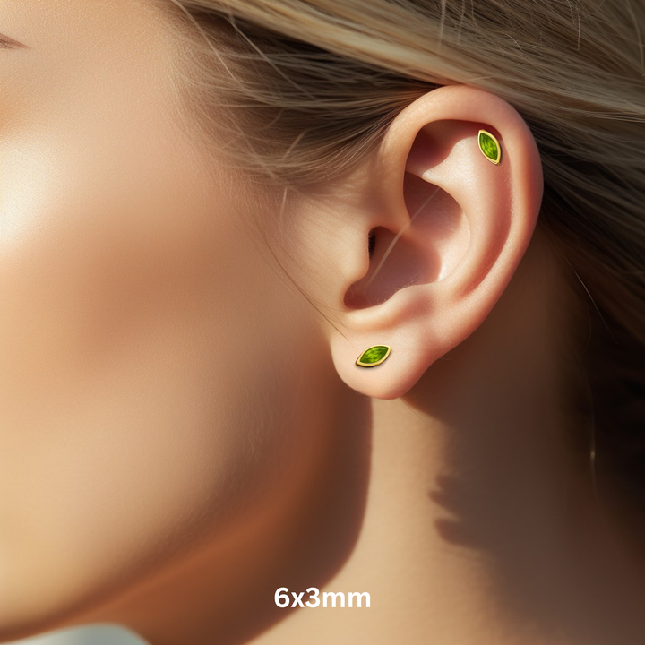 Marquise Cut Peridot Stud Earrings for Earlobe or Helix Piercings, 14K Gold Peridot Studs in Modern Minimalist Bezel Set Style, August Birthstone Earrings for Men or Women, Available as Single Earring or in Pairs, 6x3mm Size Shown on Ear Model | Rare Earth Jewelry