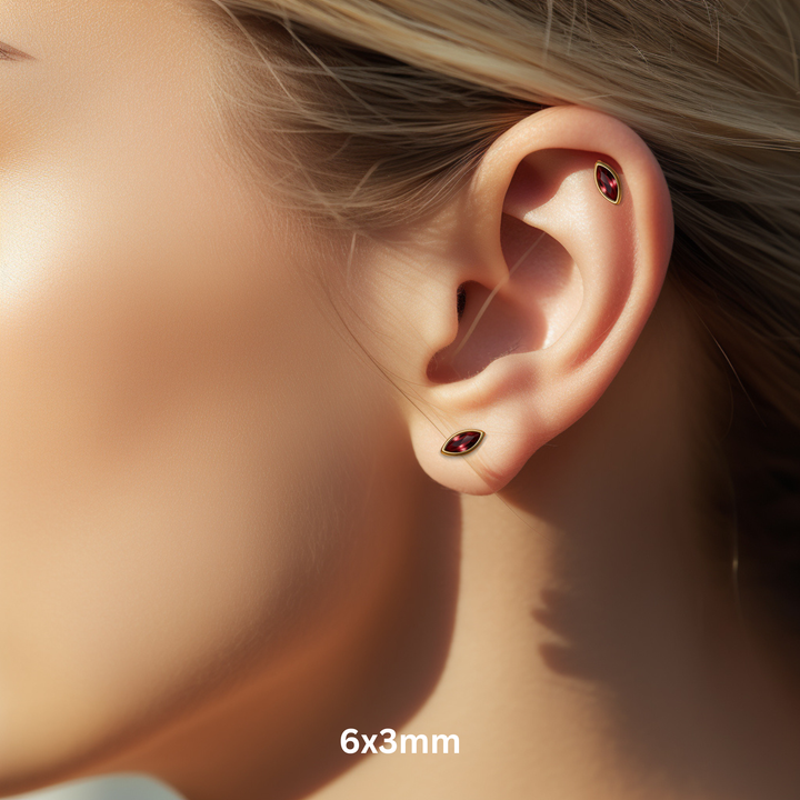 Marquise Cut Garnet Earrings on Model, 6x3mm Size on Ear in 14K Gold, Minimalist Bezel Set Studs for Helix or Earlobe Piercing, Unisex Style | Rare Earth Jewelry