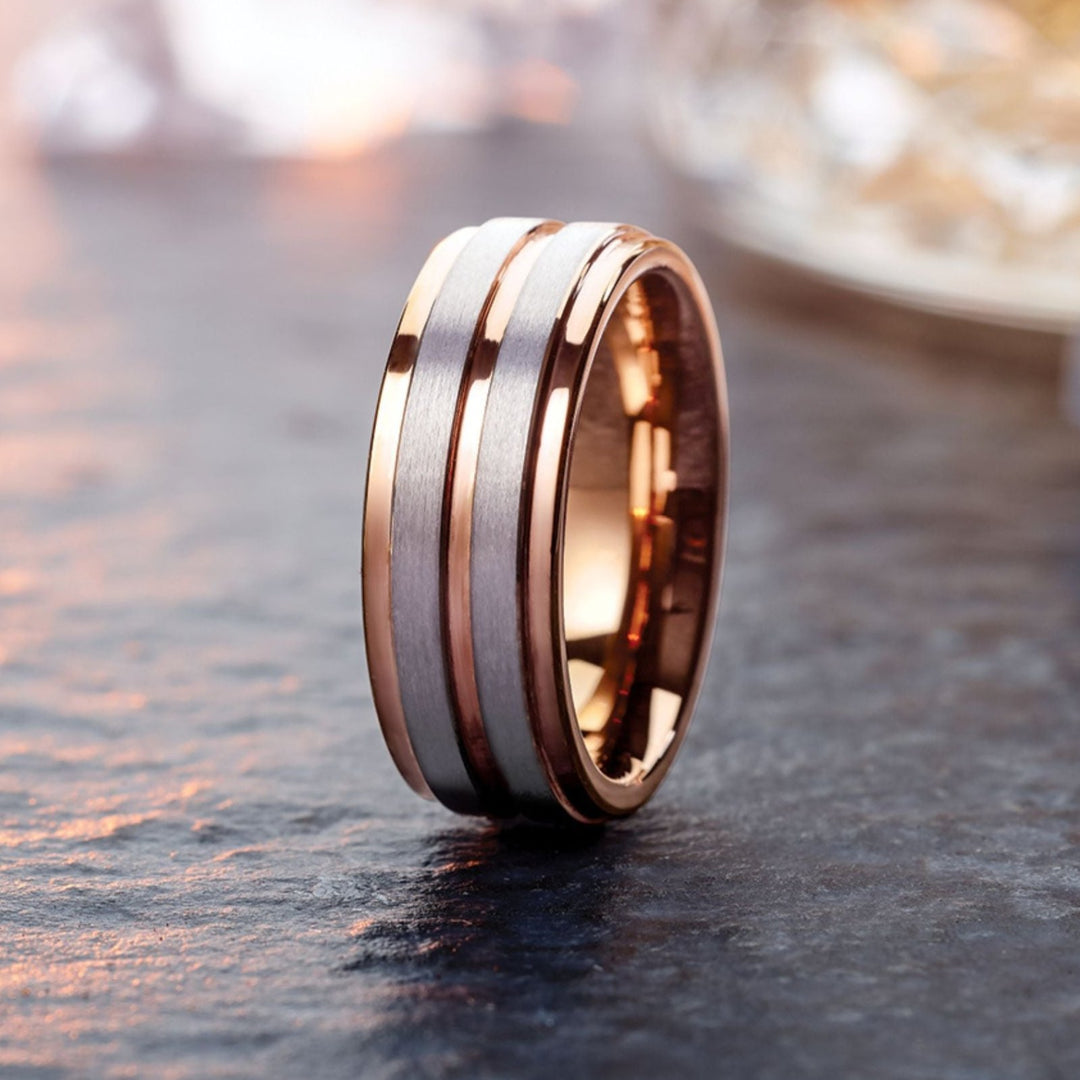 A men's or women's grooved wedding band with tungsten and rose gold from Rare Earth Jewelry.