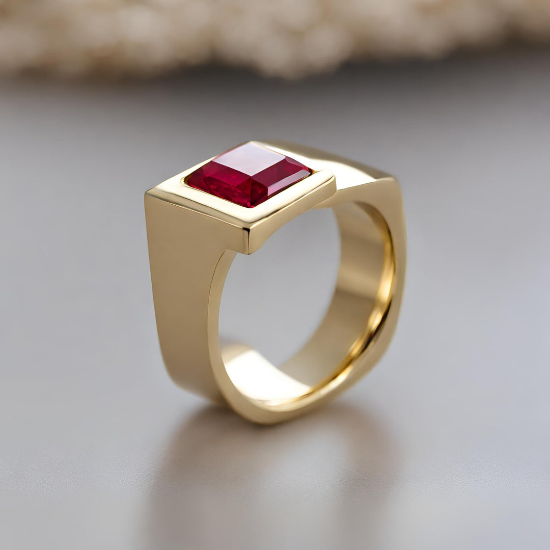 A square ruby ring for men or women with a contemporary asymmetrical design in yellow gold from Rare Earth Jewelry.