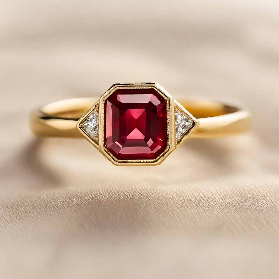 A Ruby engagement ring with a modern, bezel set geometric design and diamond accents from Rare Earth Jewelry.