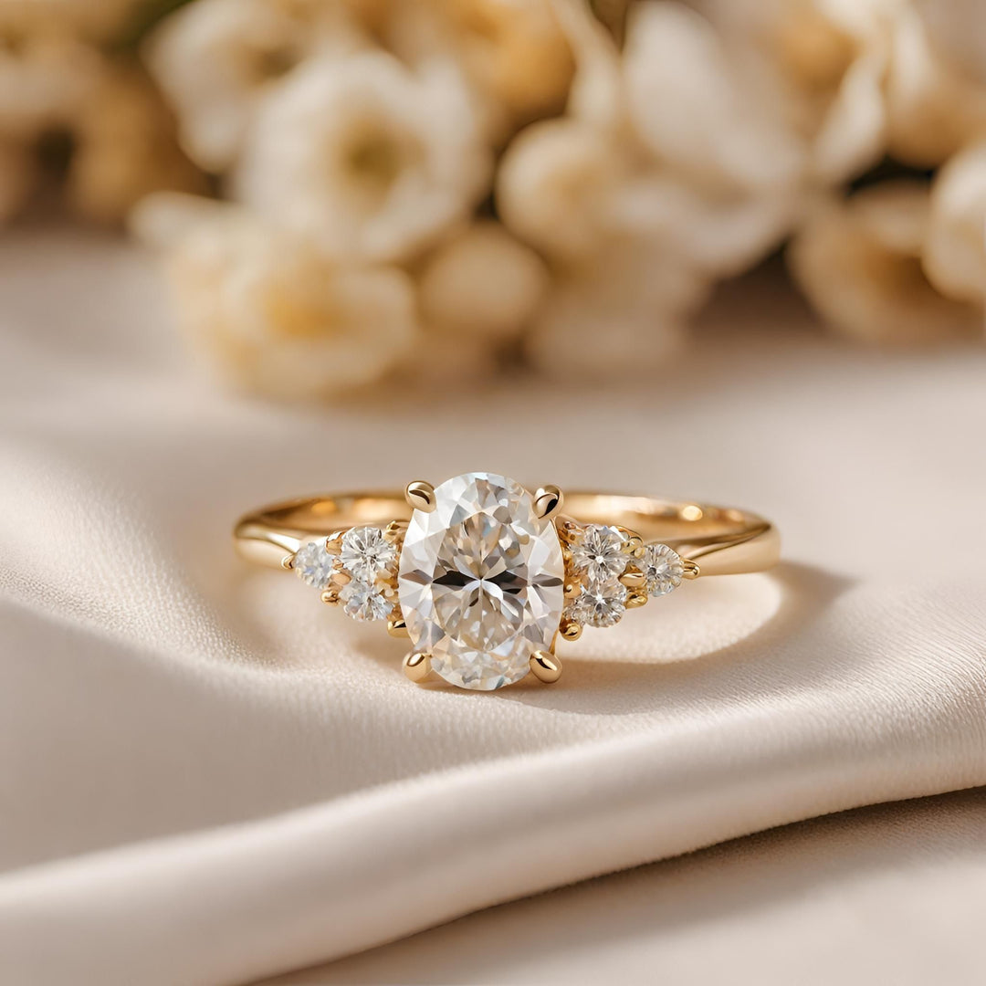 A moissanite oval engagement ring classic design with three accents on each side in 18K Yellow Gold.