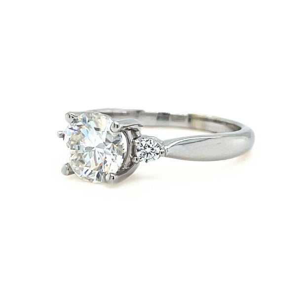 Moissanite round three stone engagementn ring in white gold with colorless Moissanite.