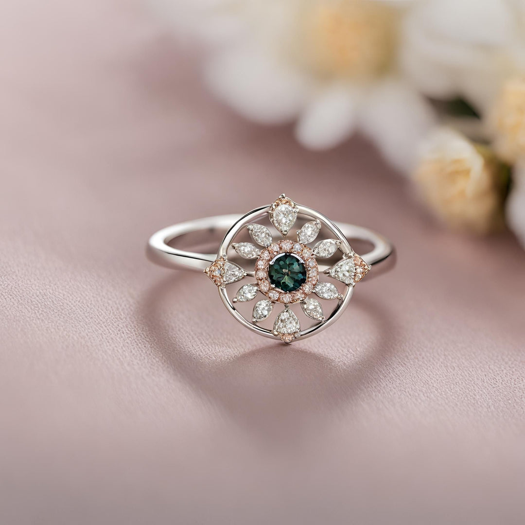 A round Montana green sapphire ring in a unique open geometric design with diamonds from Rare Earth Jewelry.