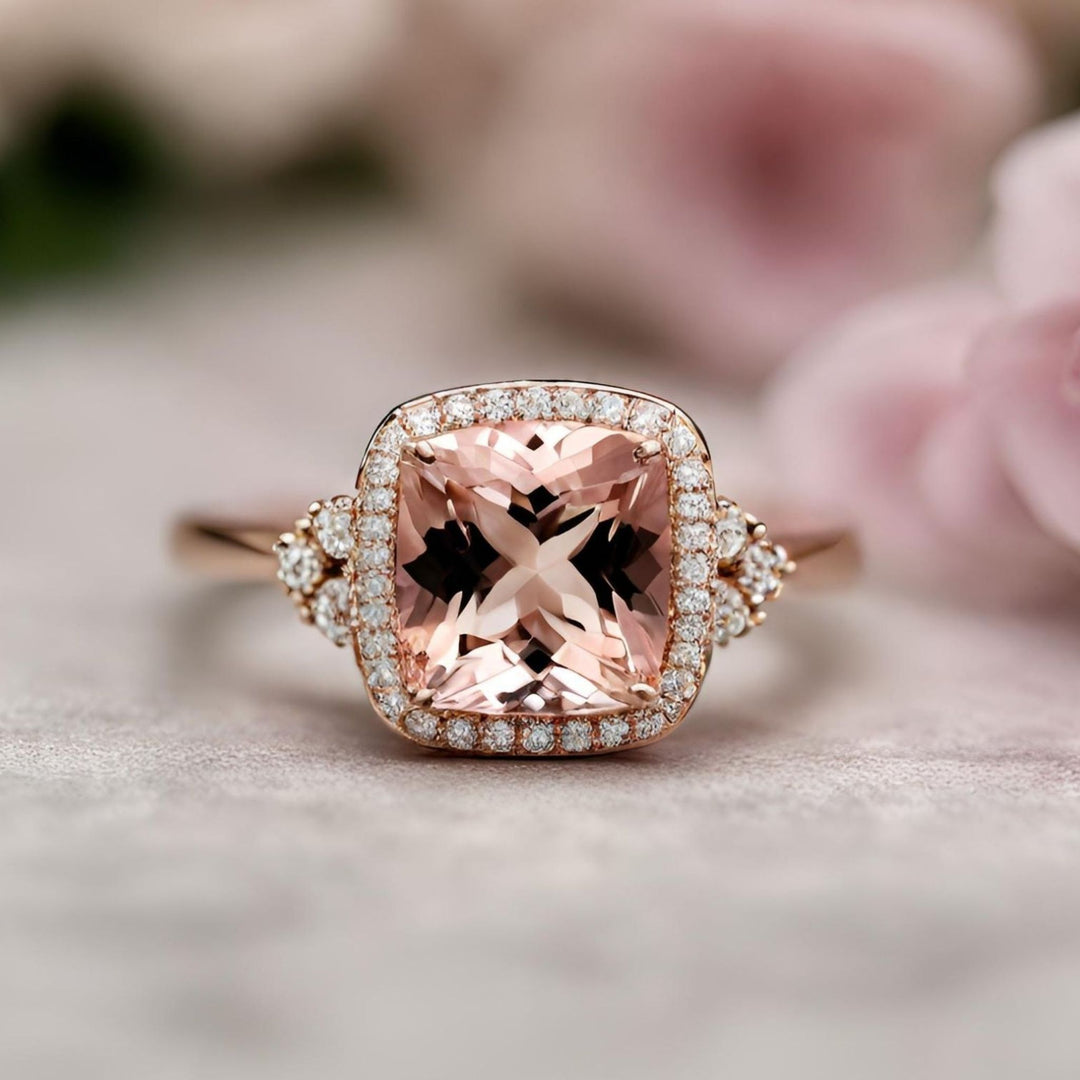 This stunning cushion cut Morganite engagement ring features a diamond halo and is set in elegant rose gold from Rare Earth Jewelry.