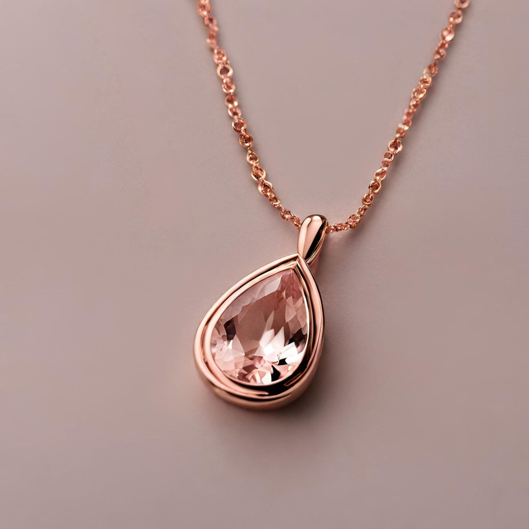 A sleek and elegant Morganite pear cut pendant in a rose gold bezel setting from Rare Earth Jewelry.