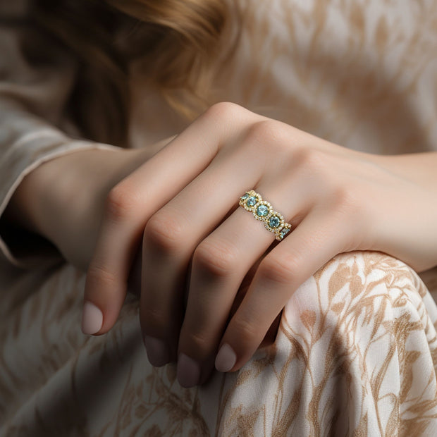 Natural Aquamarine and diamond halo ring on the finger. Unique wedding ring or anniversary band in yellow gold.