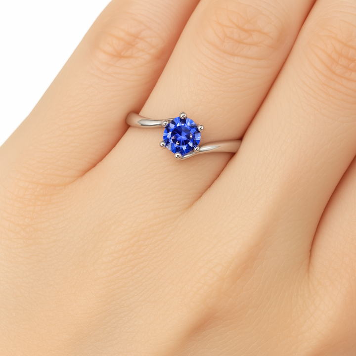 Natural blue sapphire engagement ring on woman’s hand with 5.5mm round Sapphire, Ceylon Blue Sapphire Ring Round Solitaire in Bypass Setting | Rare Earth Jewelry