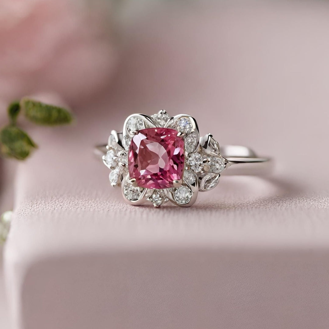 A natural pink spinel gemstone engagement ring in an antique style design with diamond accents in white gold from Rare Earth Jewelry.