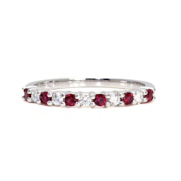 Natural ruby and diamond band or wedding ring with alternating red rubies and diamonds. July birthstone ring in white gold.