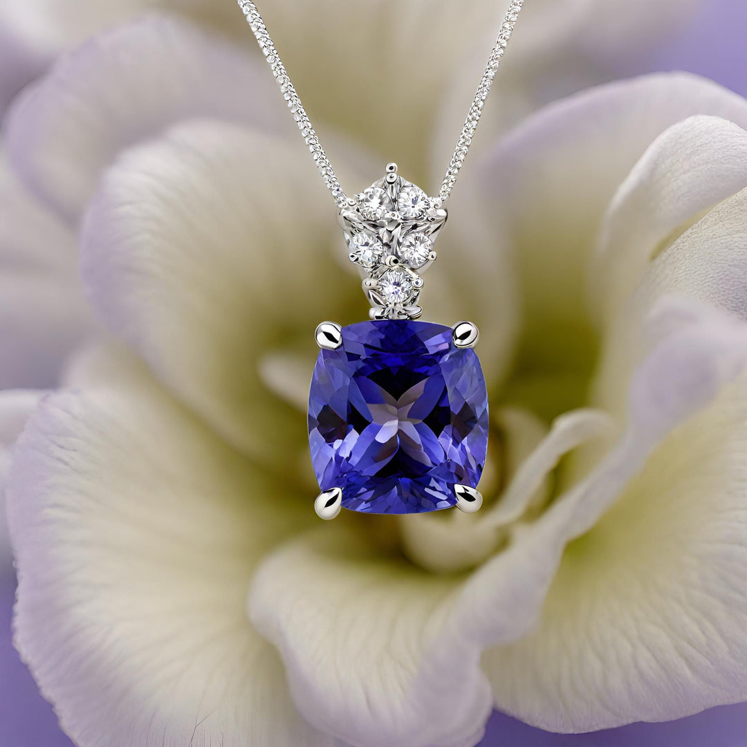 A large cushion cut natural Tanzanite pendant with a stylish diamond set bail 14K Gold necklace from Rare Earth Jewelry.