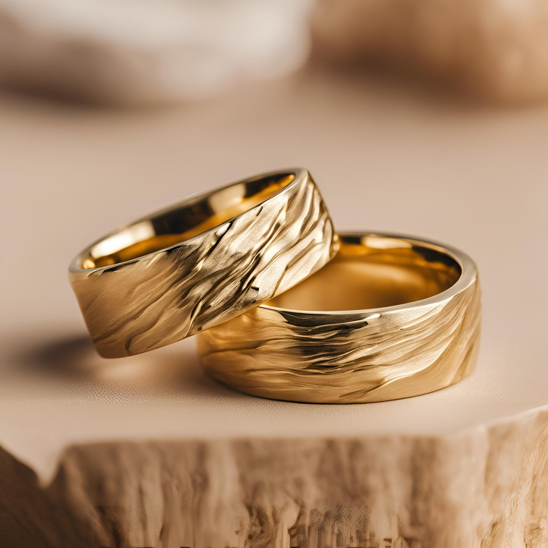 A pair of 18K Gold nature inspired wedding bands with a cascading water design for men or women from Rare Earth Jewelry.